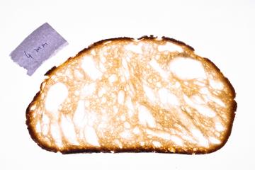 A slice of sourdough bread with a piece of paper saying 4mm beside it