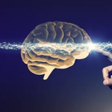 Image of finger touching brain with sparks of electricity